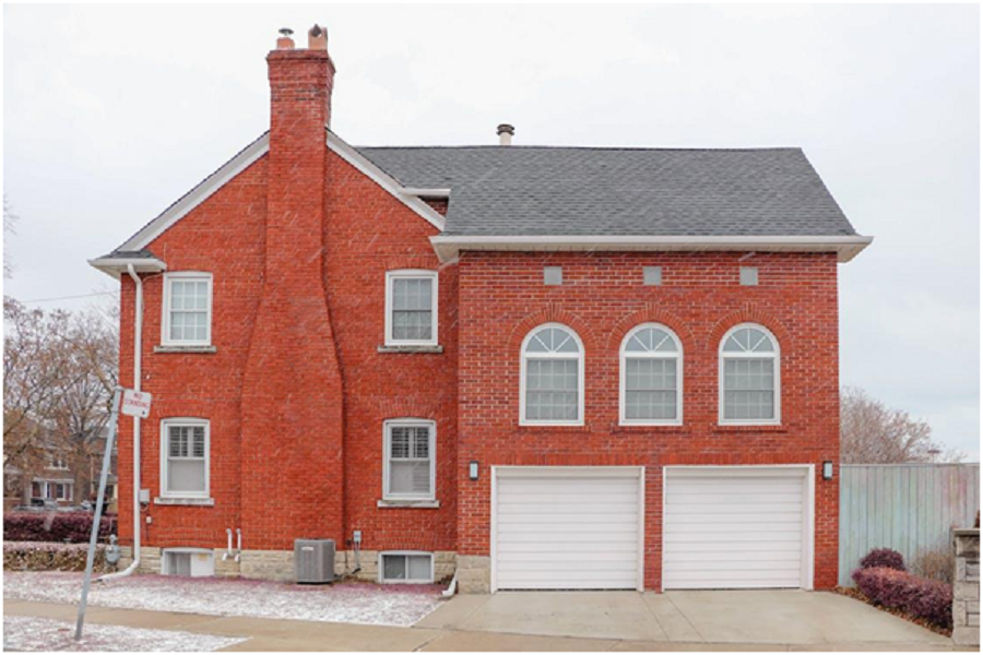 a home with a brick wall. 