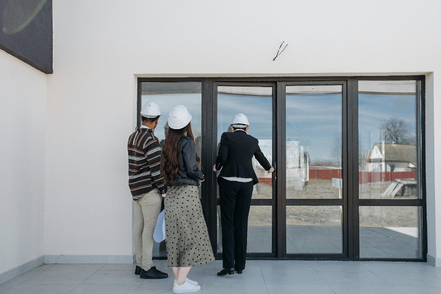 Real estate agent showing potential buyers a house