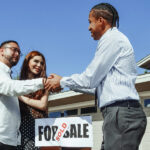 Real estate agent shaking hands with a client